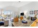 Bright living room with dining area, balcony access, comfortable seating, and modern entertainment center at 1342 Pelican Watch Villas, Seabrook Island, SC 29455