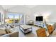 Bright living room with sliding glass doors to a balcony, comfortable seating, and modern entertainment setup at 1342 Pelican Watch Villas, Seabrook Island, SC 29455
