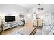 Open-concept living space with a TV, comfortable seating, dining area, and views into the kitchen at 1342 Pelican Watch Villas, Seabrook Island, SC 29455