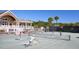 Active tennis courts with players in action, surrounded by palm trees and a clubhouse backdrop at 1342 Pelican Watch Villas, Seabrook Island, SC 29455