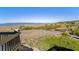 Stunning ocean and beach view from balcony with coastal vegetation and boardwalk below at 1342 Pelican Watch Villas, Seabrook Island, SC 29455