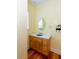 Well lit bathroom with vanity, granite counters, and oval mirror at 1392 Eden Rd, Awendaw, SC 29429