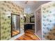 Tropical bathroom featuring vibrant wallpaper, vanity, and a sleek glass-enclosed shower at 1392 Eden Rd, Awendaw, SC 29429