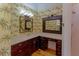 Tropical bathroom featuring vibrant wallpaper, vanity with dual mirrors, and great natural light at 1392 Eden Rd, Awendaw, SC 29429