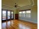 Bright bedroom with hardwood floors, shuttered windows, and a private deck at 1392 Eden Rd, Awendaw, SC 29429