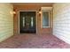 Charming home entrance featuring a classic front door, sidelight window, and a brick paved porch at 1392 Eden Rd, Awendaw, SC 29429
