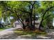 Lovely home featuring a long driveway and a two-car garage surrounded by mature trees at 1392 Eden Rd, Awendaw, SC 29429