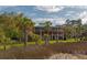 Picturesque elevated home with screened porch, showcasing its serene waterfront location at 1392 Eden Rd, Awendaw, SC 29429