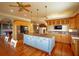 Open kitchen with island, hardwood floors, modern appliances, and ample natural light at 1392 Eden Rd, Awendaw, SC 29429