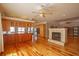 Open-concept living room with fireplace, hardwood floors, and a seamless flow to kitchen at 1392 Eden Rd, Awendaw, SC 29429