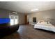 Large living room with laminate floors, TV, and bedroom area at 1392 Eden Rd, Awendaw, SC 29429