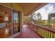 Inviting screened porch with wood floors, railing, and picturesque outdoor views at 1392 Eden Rd, Awendaw, SC 29429