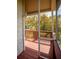 Inviting screened porch with wood floors, railing, and picturesque outdoor views at 1392 Eden Rd, Awendaw, SC 29429