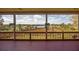 Inviting screened porch with wood floors, railing, and picturesque outdoor views at 1392 Eden Rd, Awendaw, SC 29429