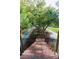 Exterior view of walkway, surrounded by lush trees with flag accent at 1392 Eden Rd, Awendaw, SC 29429