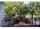 View of the walkway lined with tropical trees, leading down to landscaped outdoor spaces at 1392 Eden Rd, Awendaw, SC 29429
