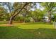 Large backyard with mature trees and a wood fence defining the property line at 1409 Lieben Rd, Mount Pleasant, SC 29466