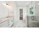 Bright bathroom with marble floors, walk-in shower, dual vanity and open doorway to walk in closet at 1409 Lieben Rd, Mount Pleasant, SC 29466