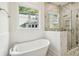 Bathroom features a soaking tub, walk in shower with marble tile and a window at 1409 Lieben Rd, Mount Pleasant, SC 29466