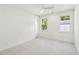 A bright bedroom featuring neutral carpet, dual windows and a modern ceiling fan at 1409 Lieben Rd, Mount Pleasant, SC 29466