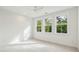 Bright bedroom with three large windows providing natural light and a ceiling fan at 1409 Lieben Rd, Mount Pleasant, SC 29466