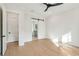 Well-lit bedroom with a sliding barn door leading into an ensuite bathroom at 1409 Lieben Rd, Mount Pleasant, SC 29466
