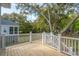 Back deck with wooden railings and stairs leading to the yard under a canopy of mature trees at 1409 Lieben Rd, Mount Pleasant, SC 29466
