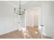 Dining room showcasing an elegant chandelier, light hardwood floors, and crisp white trim at 1409 Lieben Rd, Mount Pleasant, SC 29466