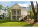 Elevated home exterior featuring a screened porch, deck, and covered parking below at 1409 Lieben Rd, Mount Pleasant, SC 29466