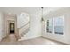 Foyer area with hardwood floors, staircase, and view of the front door and large windows at 1409 Lieben Rd, Mount Pleasant, SC 29466