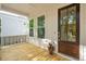 Welcoming front porch with wood flooring, large windows, and a stylish front door, perfect for relaxing at 1409 Lieben Rd, Mount Pleasant, SC 29466