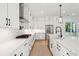 A modern kitchen featuring white cabinets, stainless steel appliances, and white backsplash and a large kitchen island at 1409 Lieben Rd, Mount Pleasant, SC 29466