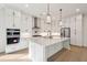 Modern kitchen with white cabinets, stainless steel appliances, island with sink and views to oven and range at 1409 Lieben Rd, Mount Pleasant, SC 29466