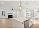 Bright, open floor plan with a modern kitchen, kitchen island, and view to the Gathering room with a fireplace at 1409 Lieben Rd, Mount Pleasant, SC 29466