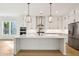 Spacious modern kitchen with stainless steel appliances, white cabinets, kitchen island with seating and view to Gathering room at 1409 Lieben Rd, Mount Pleasant, SC 29466