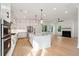 Bright, modern kitchen with an island, stainless steel appliances and lighting; part of an open floor plan at 1409 Lieben Rd, Mount Pleasant, SC 29466