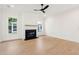 This living room has a black fireplace, wood paneling, two windows, and wood flooring and is modern at 1409 Lieben Rd, Mount Pleasant, SC 29466