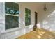 Charming covered porch featuring natural wood flooring, stylish windows, and a welcoming entryway at 1409 Lieben Rd, Mount Pleasant, SC 29466