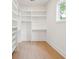 Walk-in closet with custom shelving and light hardwood floors at 1409 Lieben Rd, Mount Pleasant, SC 29466