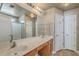 Bathroom with double sink vanity, large mirror, and a walk-in shower behind glass doors at 1436 Harbor Mist Ct, Charleston, SC 29492