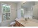 Bright bathroom with a large mirror, window, and a shower-tub combination at 1436 Harbor Mist Ct, Charleston, SC 29492
