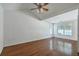 Spacious bedroom showcasing vaulted ceilings, wood floors, ceiling fan, and ample natural light at 1436 Harbor Mist Ct, Charleston, SC 29492