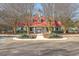 Community clubhouse featuring a red roof, gray siding, and mature trees at 1436 Harbor Mist Ct, Charleston, SC 29492
