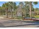 Entrance to the community with mature landscaping and a sign that reads 'Peninsula' at 1436 Harbor Mist Ct, Charleston, SC 29492