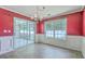 Elegant dining room features a stylish chandelier, large windows, and sliding glass doors to the outdoor patio at 1436 Harbor Mist Ct, Charleston, SC 29492