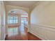 Inviting entryway with hardwood floors, arched doorways, and decorative wall paneling, leading to bright, open living spaces at 1436 Harbor Mist Ct, Charleston, SC 29492