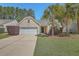 Charming single-story home featuring a well-manicured lawn, palm trees, and an attached two-car garage at 1436 Harbor Mist Ct, Charleston, SC 29492