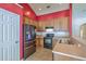 Modern kitchen with wooden cabinets, stainless steel refrigerator, and views into the adjacent living areas at 1436 Harbor Mist Ct, Charleston, SC 29492