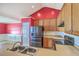 Cozy kitchen featuring stainless steel appliances, wood cabinets, and a sink overlooking adjacent room at 1436 Harbor Mist Ct, Charleston, SC 29492