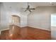 Spacious living room featuring gleaming hardwood floors, a ceiling fan, and an open layout for seamless entertaining at 1436 Harbor Mist Ct, Charleston, SC 29492